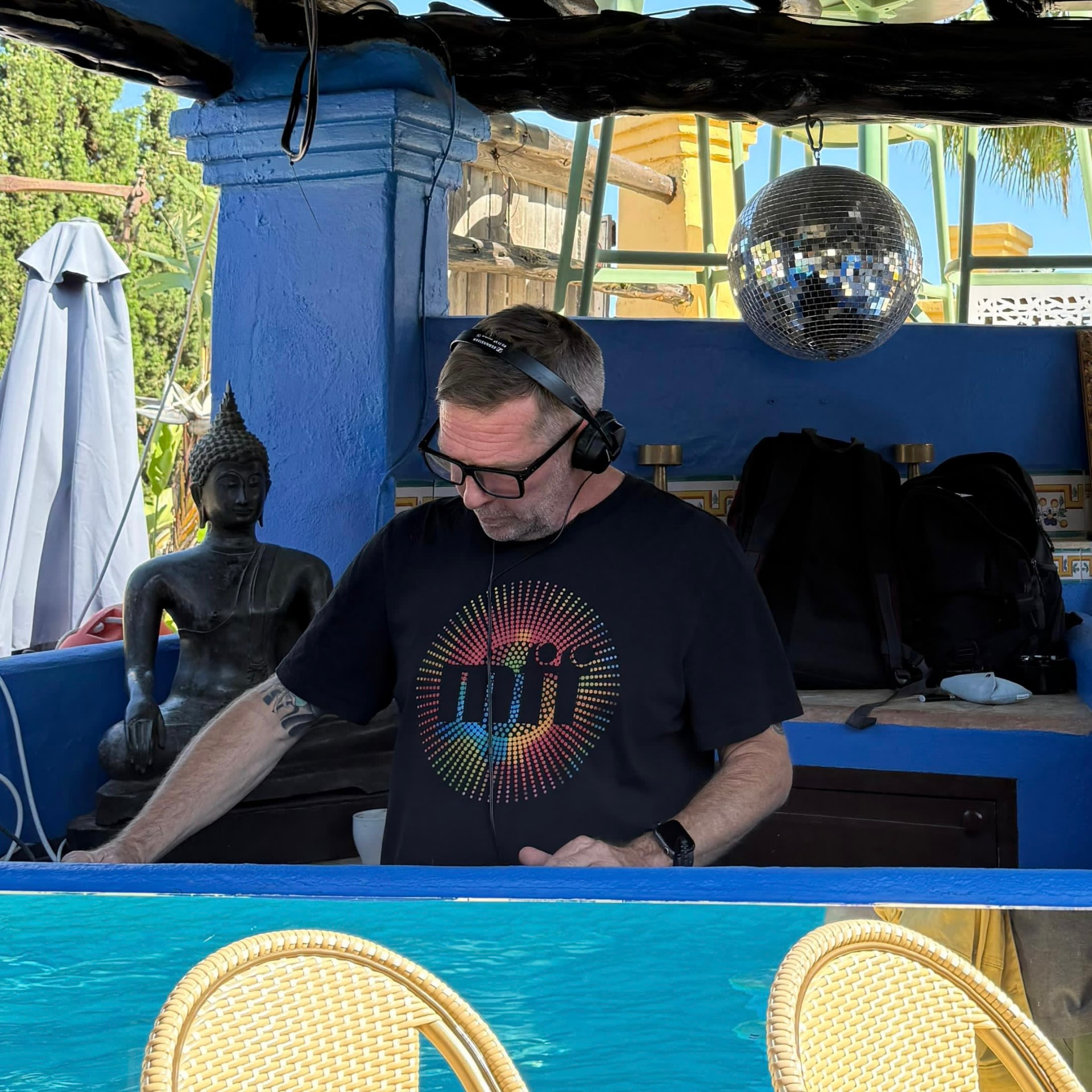 Justin Harris DJing outdoors by a pool